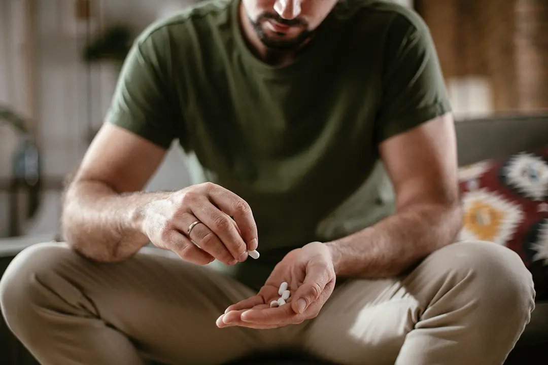 man holding pills